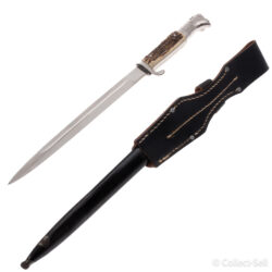 A World War II German dress bayonet with a polished blade, etched with the inscription “Zur Erinnerung an meine Dienstzeit,” decorative scrollwork, and a Wehrmacht eagle. The handle features stag horn grips, and the set includes a black-painted scabbard and leather frog.