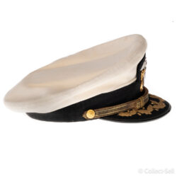 Side view of a U.S. Navy officer’s white combination cap, highlighting the curved black visor with gold embroidery, the gold chin strap, and the detailed side buttons.