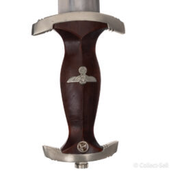 An authentic German NSKK dagger featuring a polished blade etched with ‘Alles für Deutschland,’ a dark-stained wooden grip with inlaid Nazi Party eagle and SA roundel, nickel-plated crossguards marked with ‘Wm,’ and a black anodized scabbard with nickel fittings and suspension ring