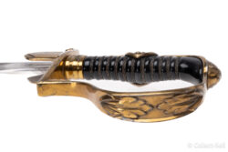 Side view of the gilded brass hilt on a WWII Prinz Eugen ceremonial sword, featuring intricate oak leaf and Nazi eagle designs