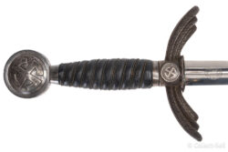 Close-up of the hilt of a Luftwaffe officer’s sword, showing the blue leather grip with silver wire wrapping and a pommel featuring a Luftwaffe eagle and swastika