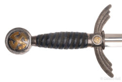 Close-up of the Luftwaffe Officer’s Sword hilt, featuring a blue leather grip, silver wire wrapping, and golden swastika sunwheel on the pommel