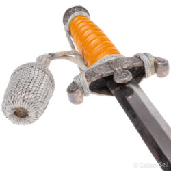 WWII German Army Officer’s Dagger featuring an orange celluloid grip, detailed Wehrmacht eagle crossguard, original silver portapee, polished blade, and pebbled metal scabbard with suspension rings