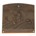 1933 Swinegellauf motorcycle rally plaque featuring a motorcyclist in motion, swastika background, and hare and hedgehog relief, issued by ADAC and motorcycle clubs from Hamburg and Buxtehude