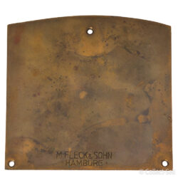 Back of 1933 Swinegellauf motorcycle rally plaque, featuring the manufacturer’s engraving ‘M. Fleck & Sohn Hamburg’ on aged metal with mounting holes