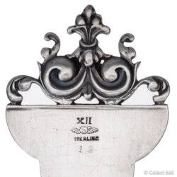 Detailed close-up of the scrollwork handle with winged S and XII mark