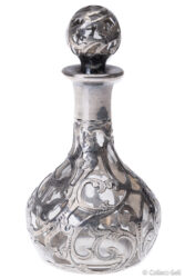 Antique silver overlay glass perfume bottle with ornate stopper, front view