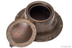 Open Roycroft hammered copper inkwell showing inner chamber and hinged lid