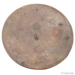 Underside of Roycroft inkwell showing maker’s mark with orb-and-cross “R” logo