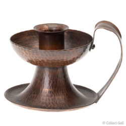 Angled view of hand-hammered Roycroft copper candle holder with loop handle