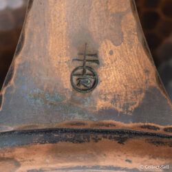 Close-up of Roycroft orb and cross maker’s mark on handle