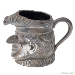 Side view of Mr. Punch sterling silver cream jug with handle, hallmarked London 1894
