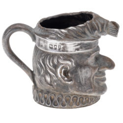 Side view of Mr. Punch sterling silver cream jug with handle, hallmarked London 1894