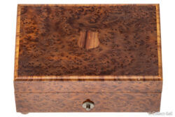 Top view showing burlwood grain and inlaid shield motif