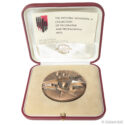 Bronze medal in red presentation case with booklet for the Mitchell Wolfson Jr. Collection of Decorative and Propaganda Arts, 1984