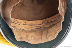 Handwritten ink name “Berthe” under sweatband of M.C. Lilley Cavalry helmet.