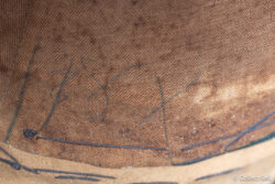 Pencil writing “18X” under sweatband of U.S. Cavalry officer helmet.